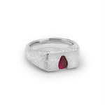 Silver ring with a red gemstone on a white background