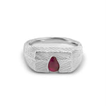 Silver ring with a red gemstone on a white background
