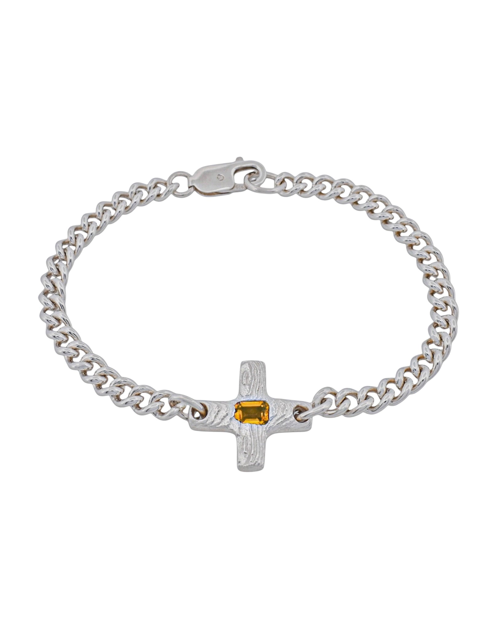 A silver chain bracelet with a textured cross charm featuring a small rectangular yellow gemstone, shown on a plain white background.