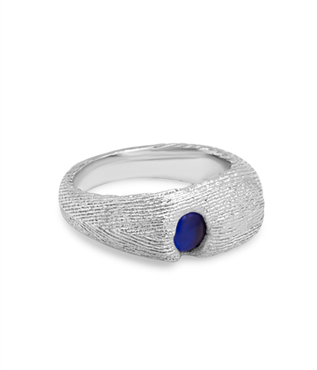Silver ring with a blue gemstone on a white background