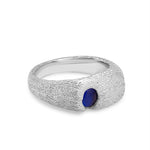 Silver ring with a blue gemstone on a white background
