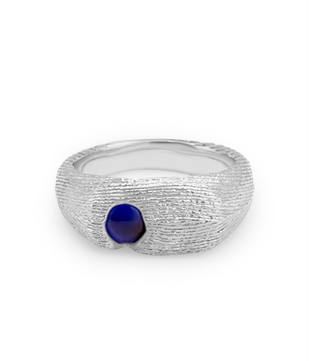 Silver ring with a blue gemstone on a white background