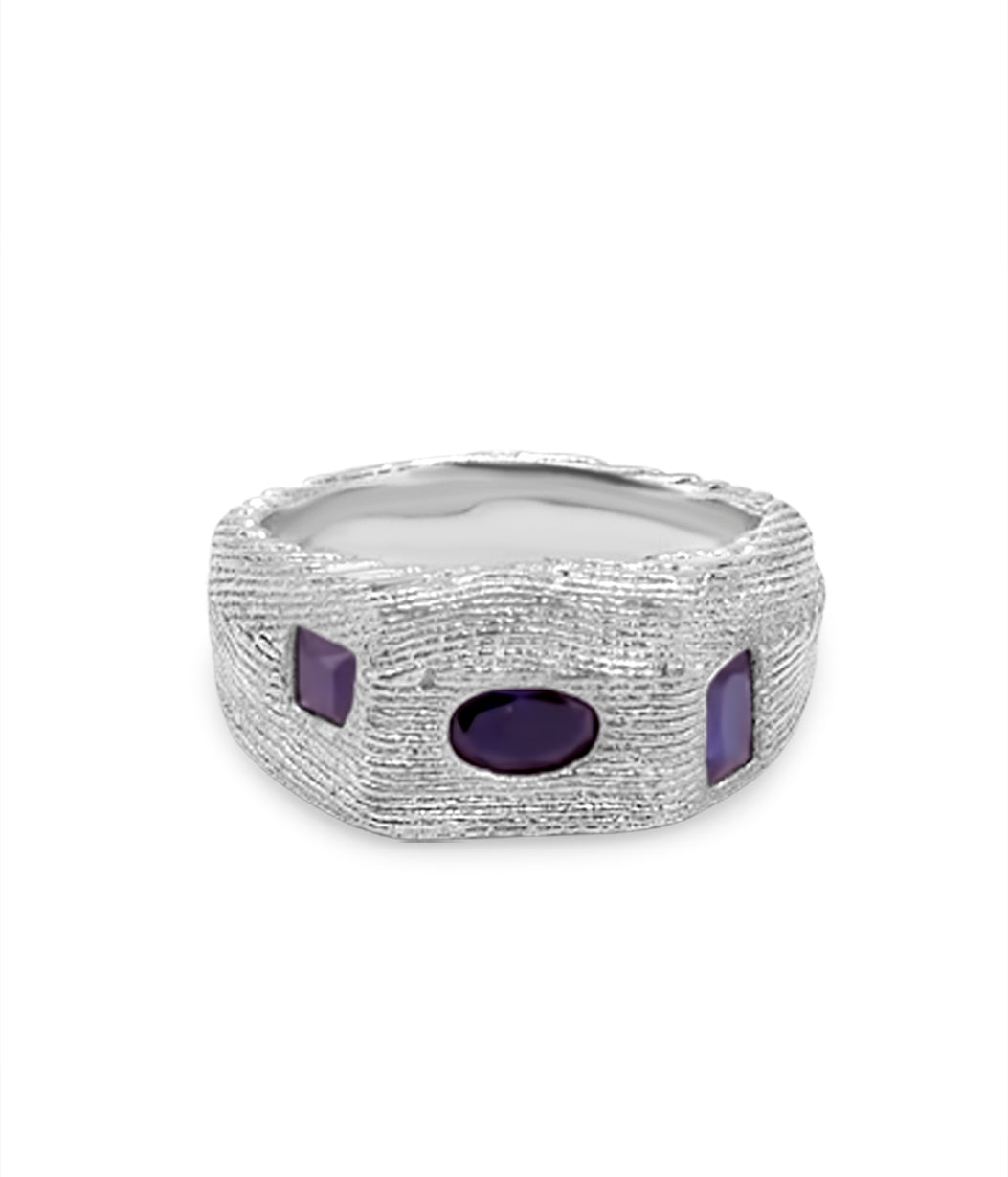 Silver ring with purple stones on a white background