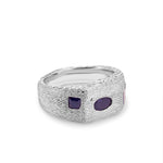 Silver ring with two purple stones on a white background