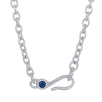A silver chain necklace featuring a hook-shaped clasp adorned with a small round blue gemstone, shown against a plain white background.