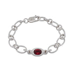 A silver chain bracelet featuring a central oval red gemstone, displayed on a clean white background.