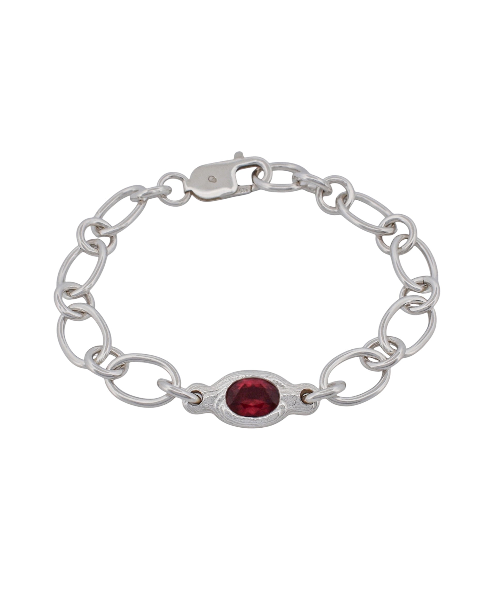 A silver chain bracelet featuring a central oval red gemstone, displayed on a clean white background.