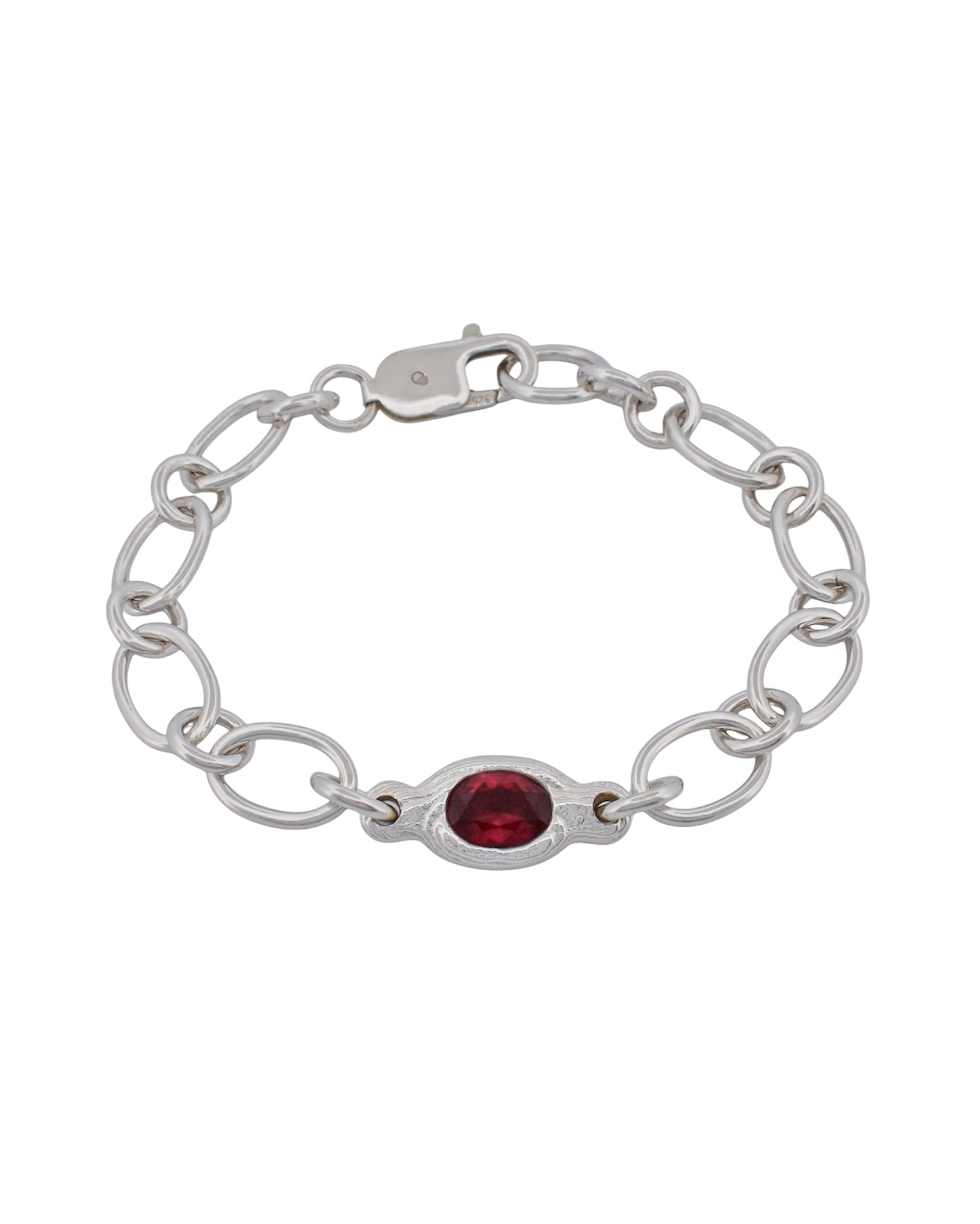 A silver chain bracelet featuring a central oval red gemstone, displayed on a clean white background.