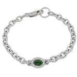 A silver chain bracelet with a central oval bezel-set green gemstone, shown on a plain white background.