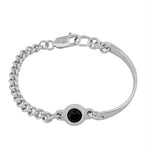 A silver-toned chain bracelet with a lobster clasp and a central round black gemstone bezel-set on a plain white background.