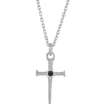 A silver cross pendant necklace with a small black gemstone at the center, suspended from a silver link chain against a plain white background.