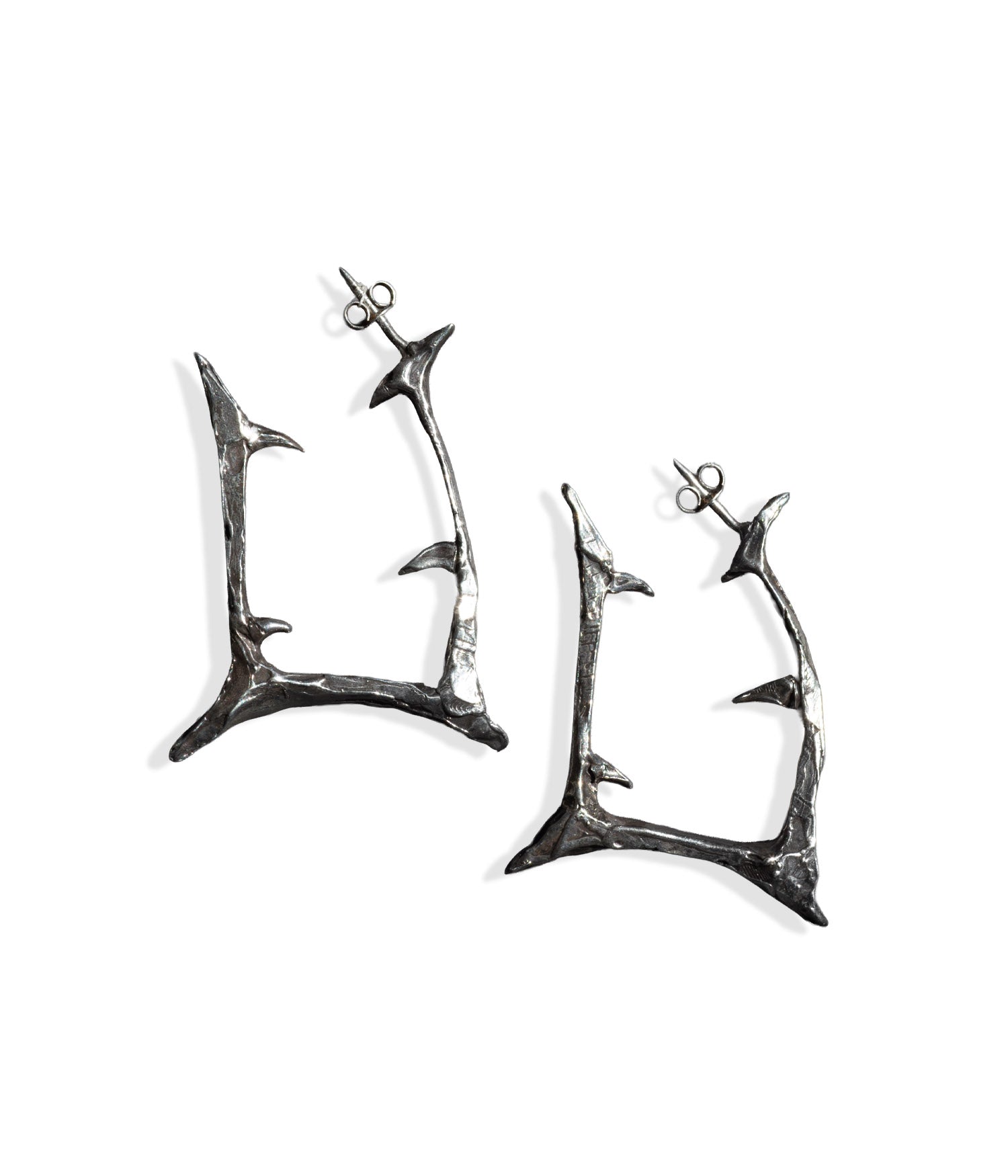 Pair of silver antler-shaped earrings on a white background