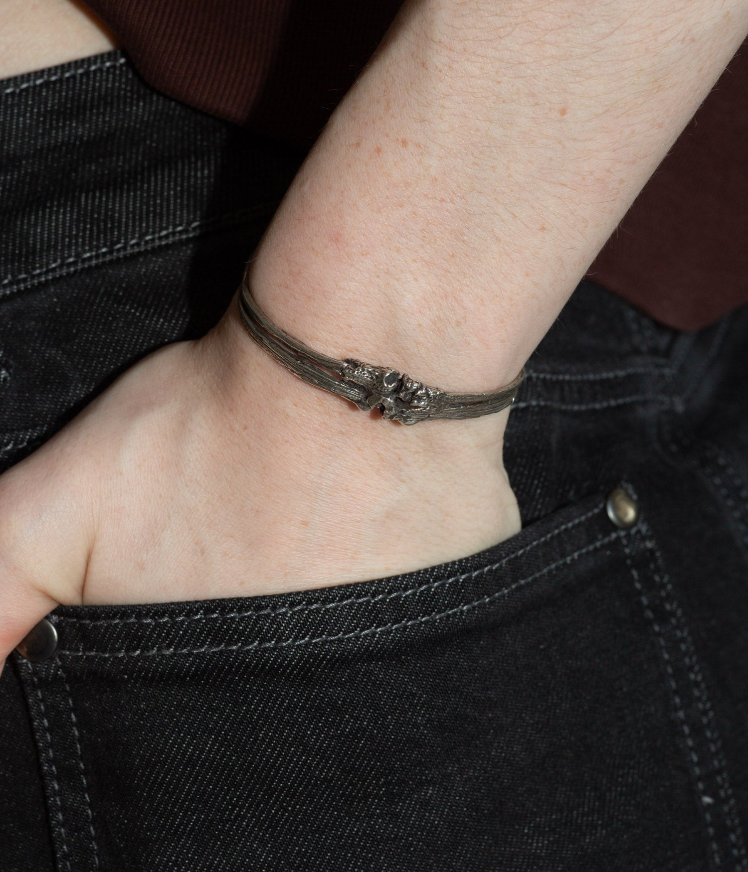 Close-up of a wrist wearing a bracelet with a dark background