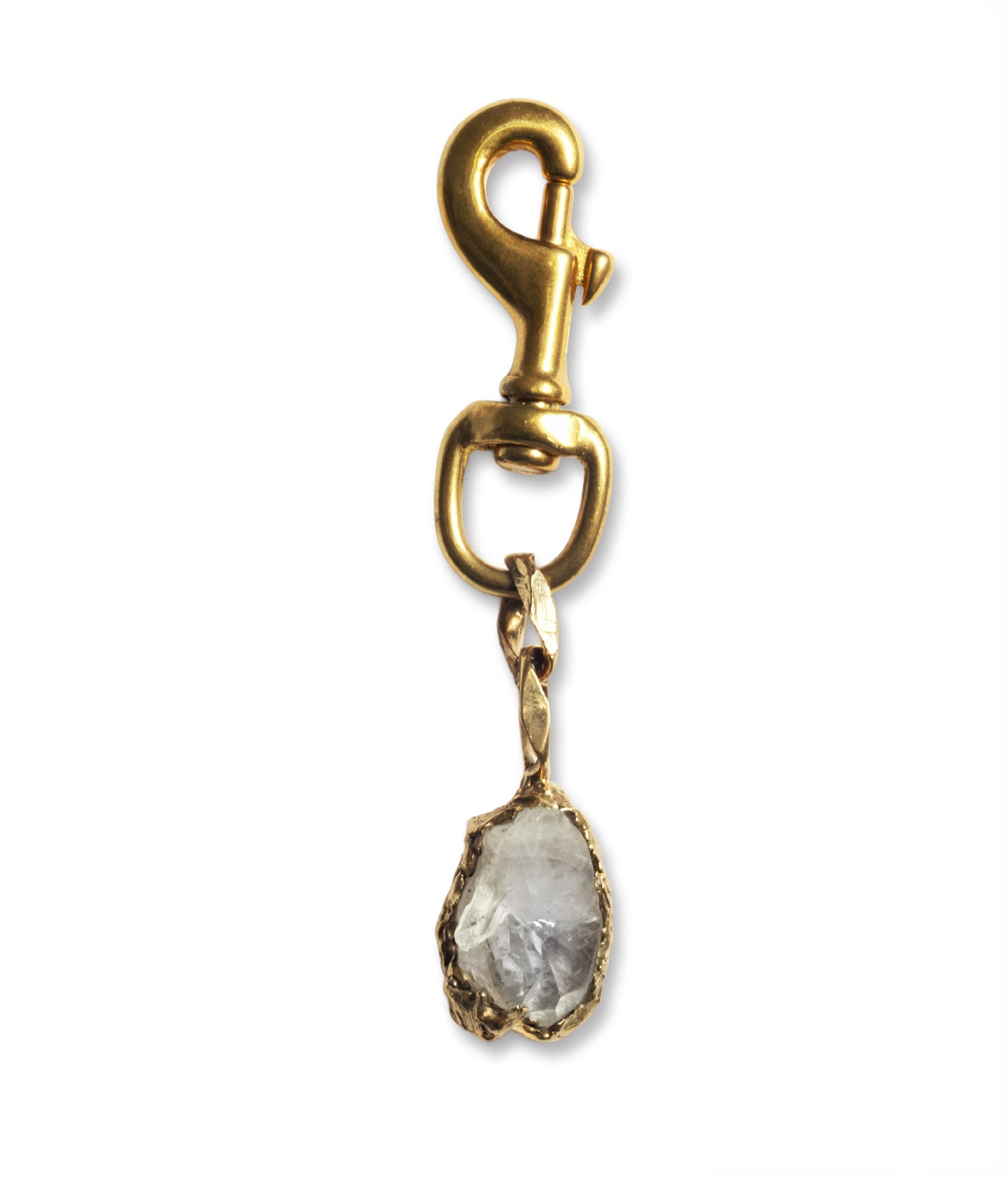 Gold charm with a natural stone on a white background