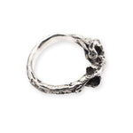 Silver ring with a textured design on a white background