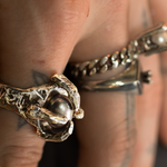 Close-up of two rings on a finger with a blurred background