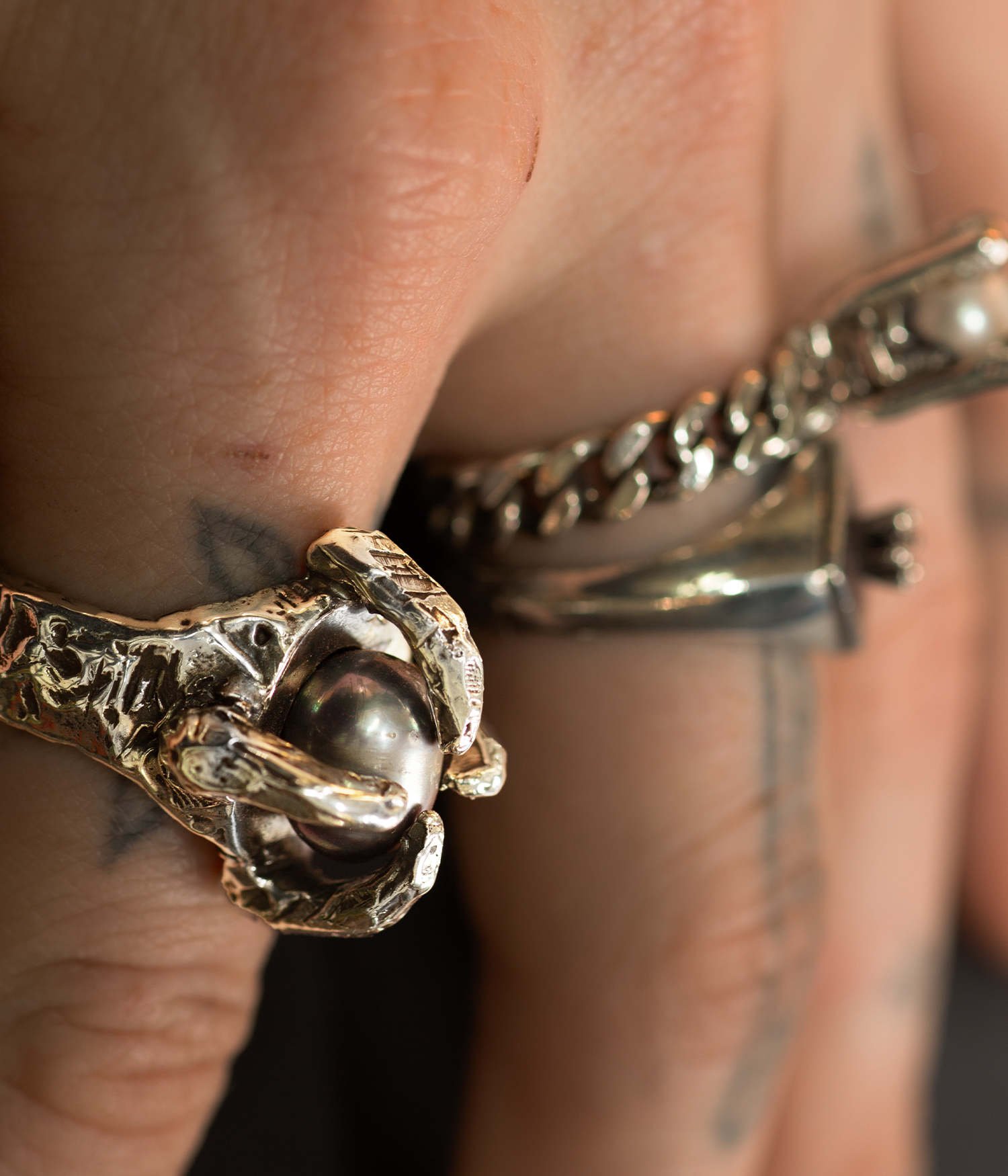 Close-up of two rings on a finger with a blurred background