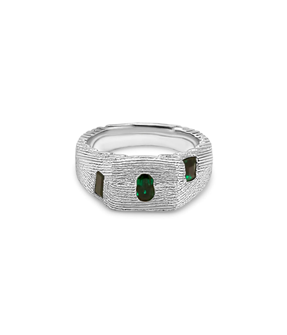 Silver ring with green gemstones on a white background