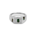 Silver ring with green gemstones on a white background