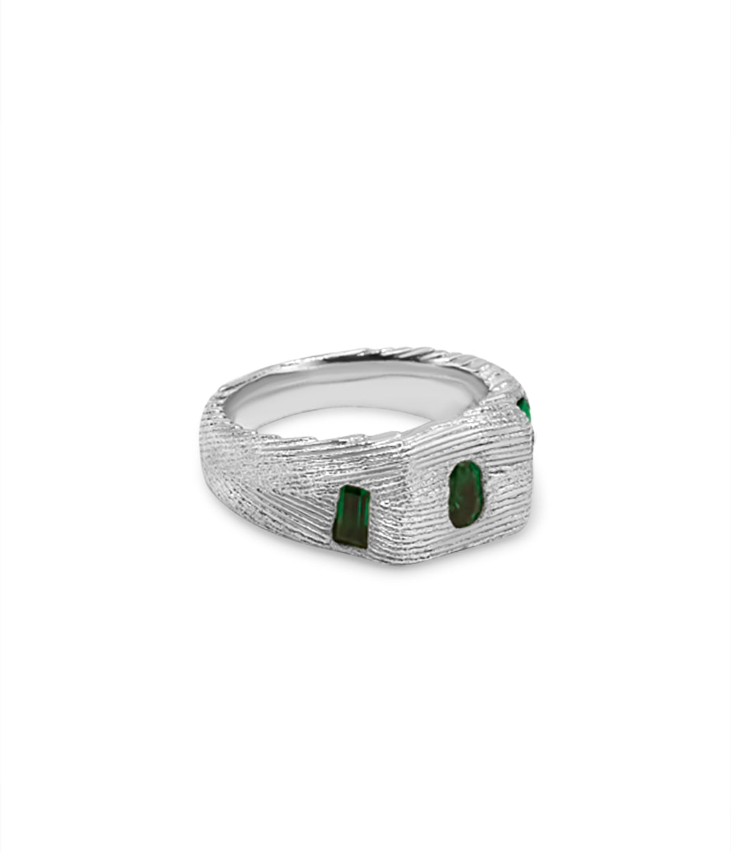 Silver ring with green gemstones on a white background