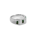 Silver ring with green gemstones on a white background