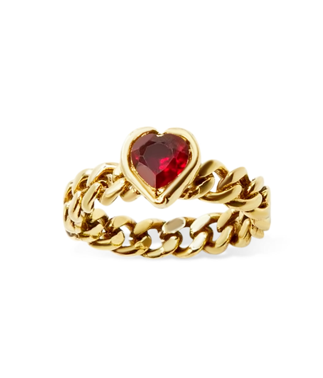 Gold ring with a heart-shaped red gemstone on a white background