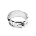 Silver ring with a textured surface on a white background