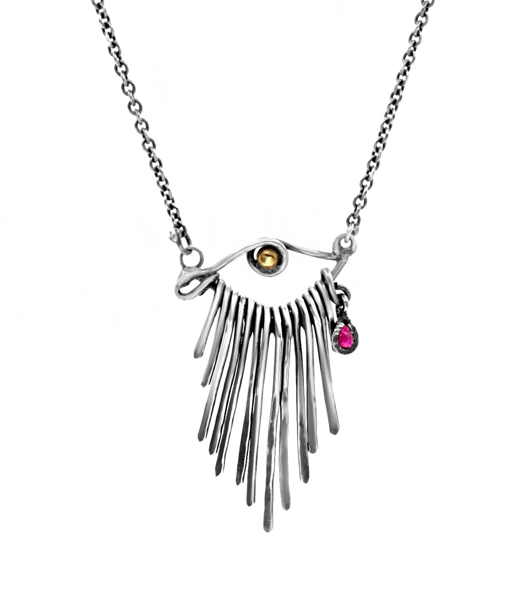 Necklace with a fringe pendant and gemstones on a white background