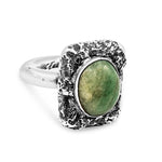 Silver ring with a green stone on a white background