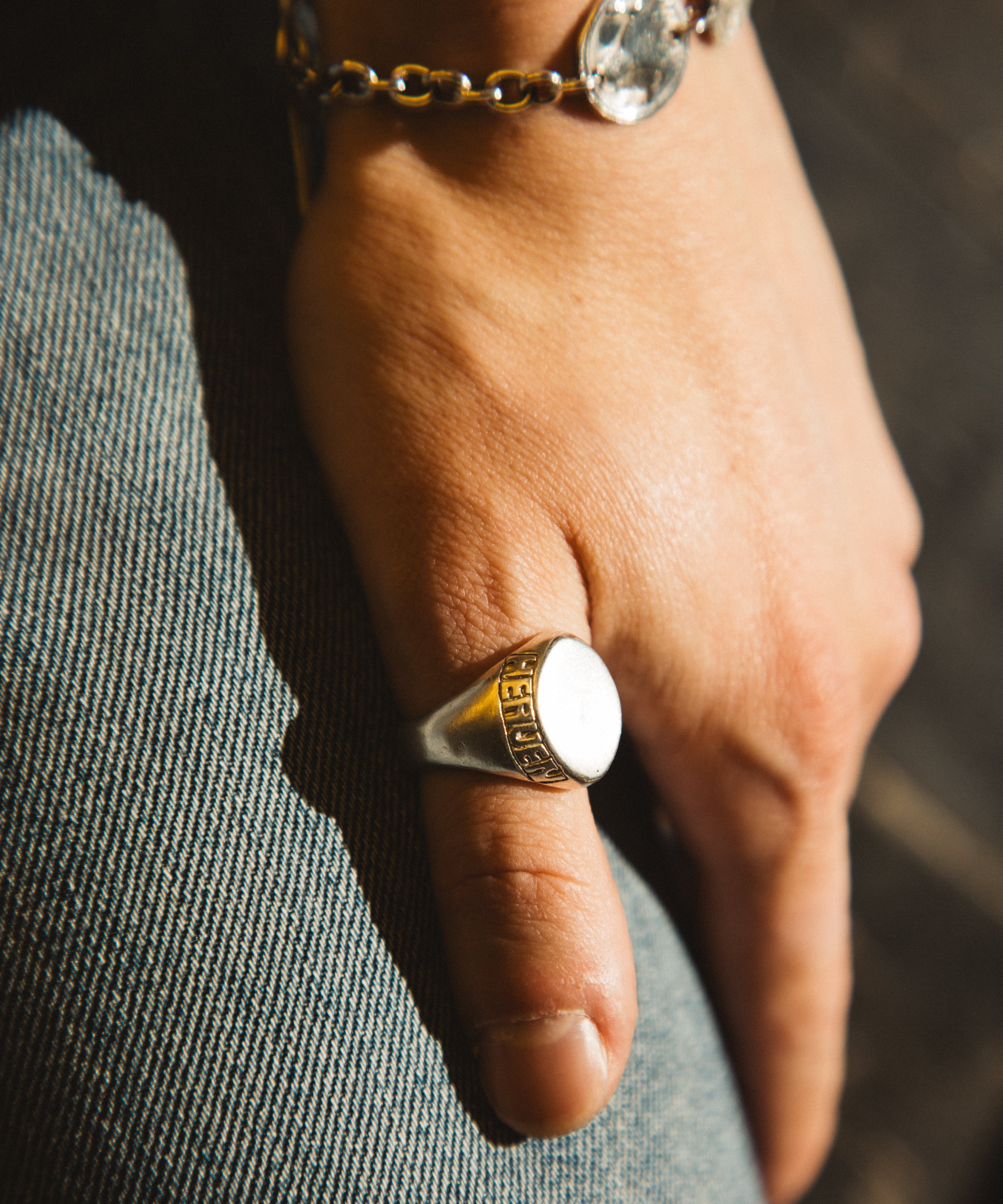Hand wearing a ring with a blurred background
