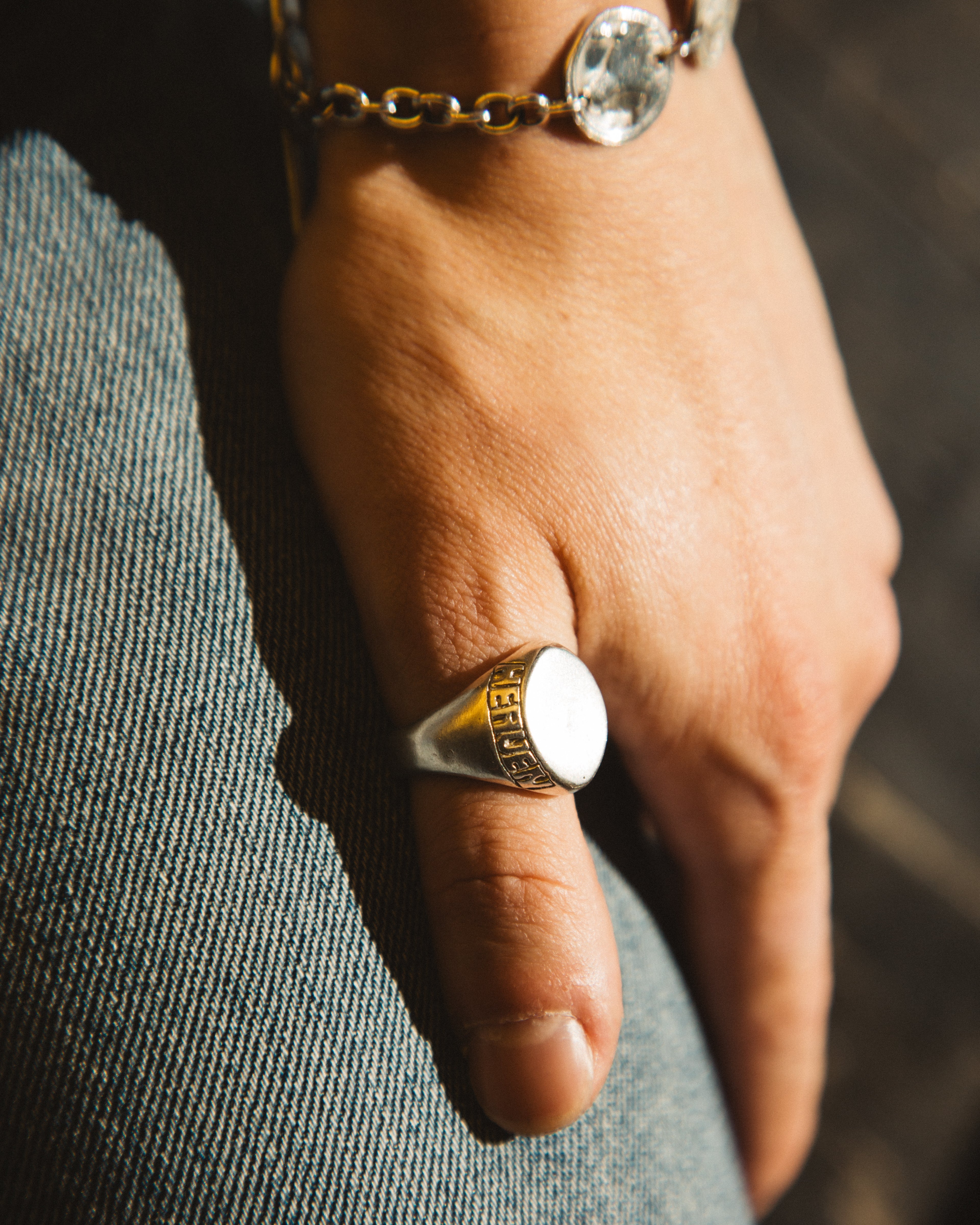 Hand wearing a ring with a blurred background