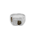Silver ring with embedded stones on a white background