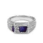 Silver ring with two purple stones on a white background