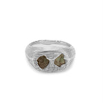 Silver ring with embedded stones on a white background