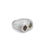 Silver ring with embedded stones on a white background