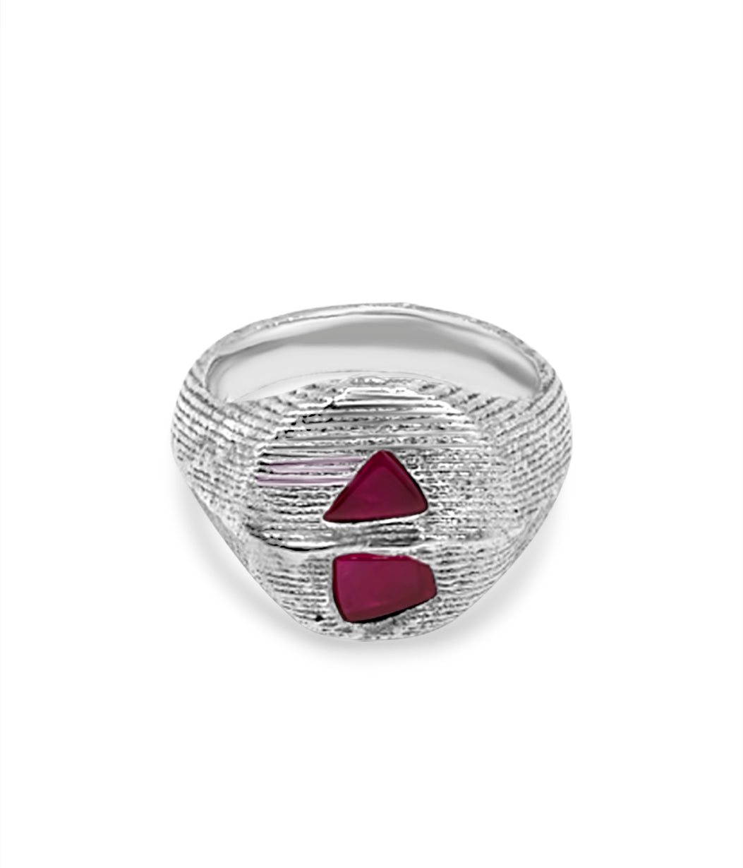 Silver ring with red gemstones on a white background