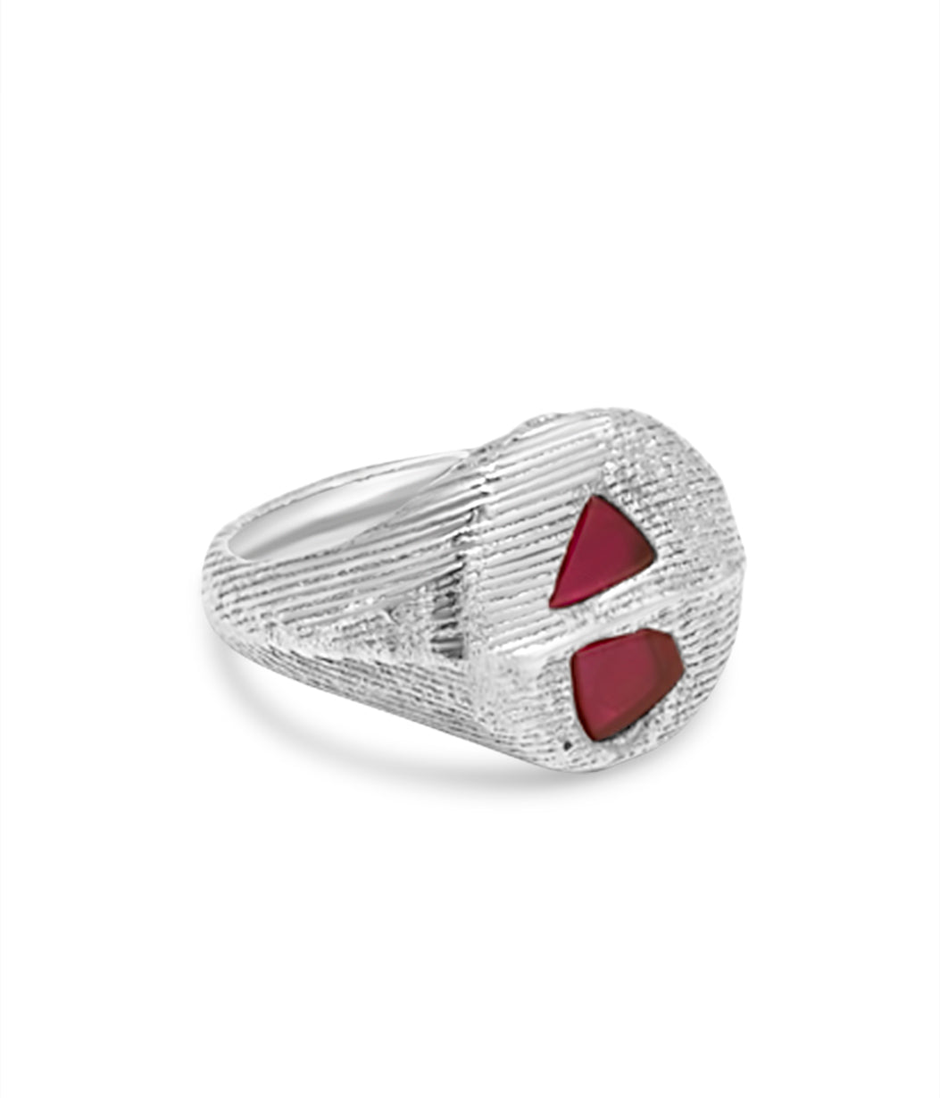 Silver ring with red stones on a white background