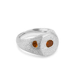 Silver ring with two embedded stones on a white background