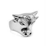 Silver bull head charm on a white background