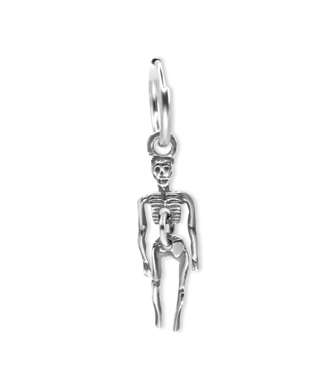 Silver skeleton charm on a white background