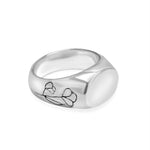 Silver ring with a design on a white background