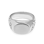 Silver ring with engraved design on a white background