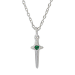 A silver pendant necklace featuring a miniature dagger or sword charm with a small, heart-shaped green gemstone at the center of the crossguard, suspended from a silver link chain against a plain white background.