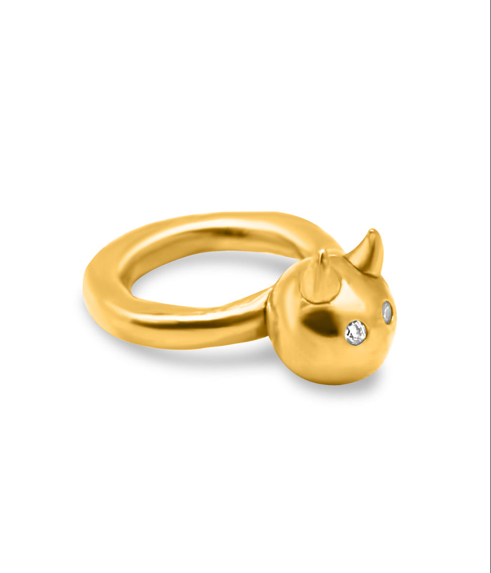 Gold cat-shaped ring with a small gemstone on a white background