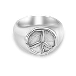 Silver ring with peace symbol design on a white background