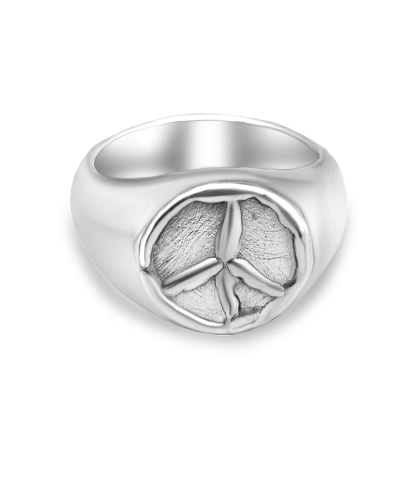 Silver ring with peace symbol design on a white background