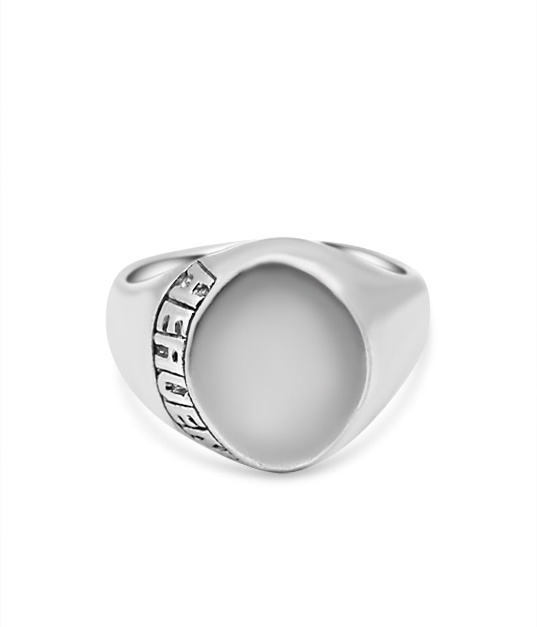 Silver ring with a textured band on a white background