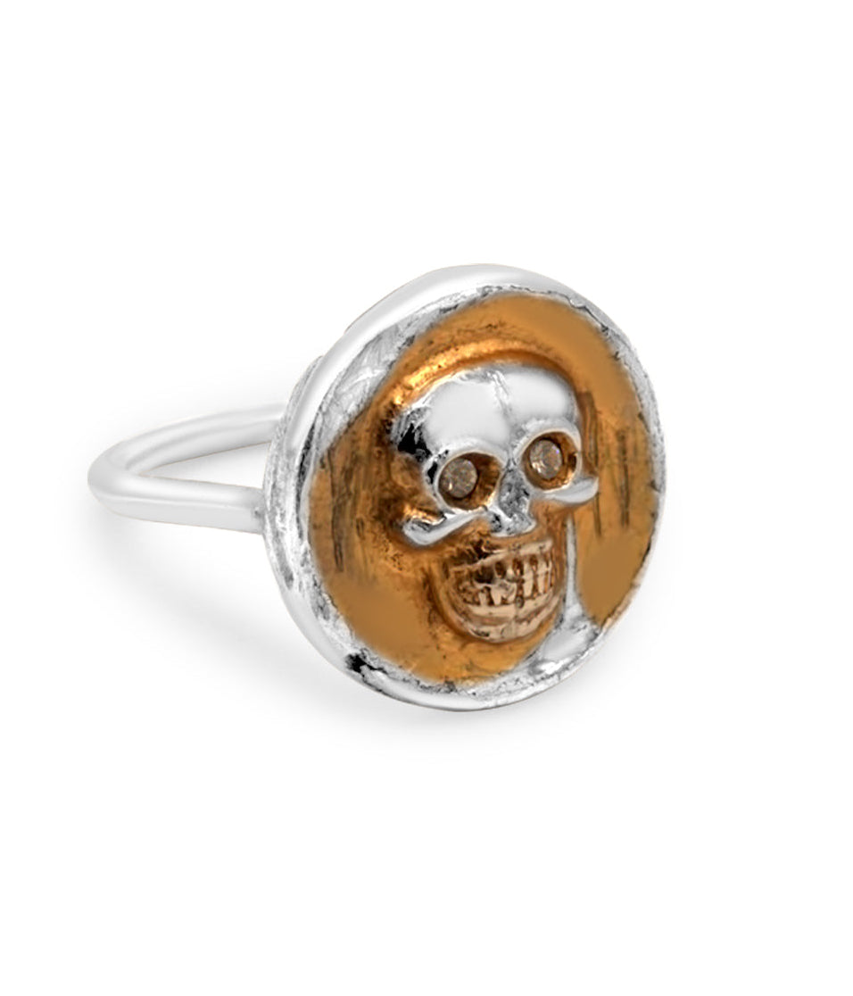 Silver and gold skull ring on a white background