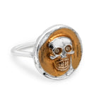 Silver and gold skull ring on a white background