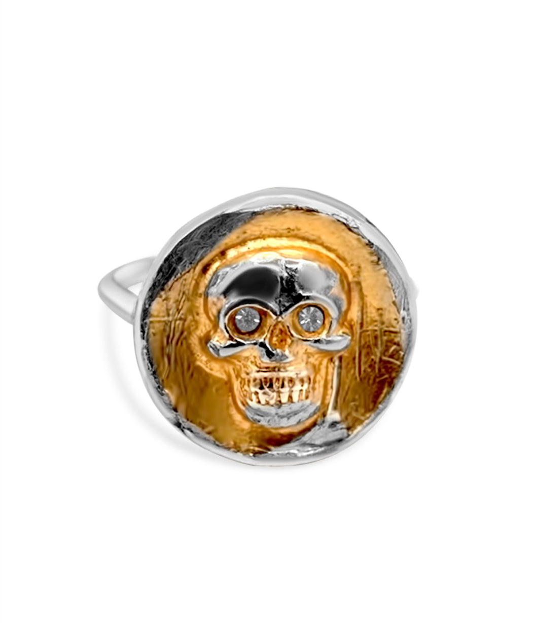 Gold and silver skull pendant on a white background